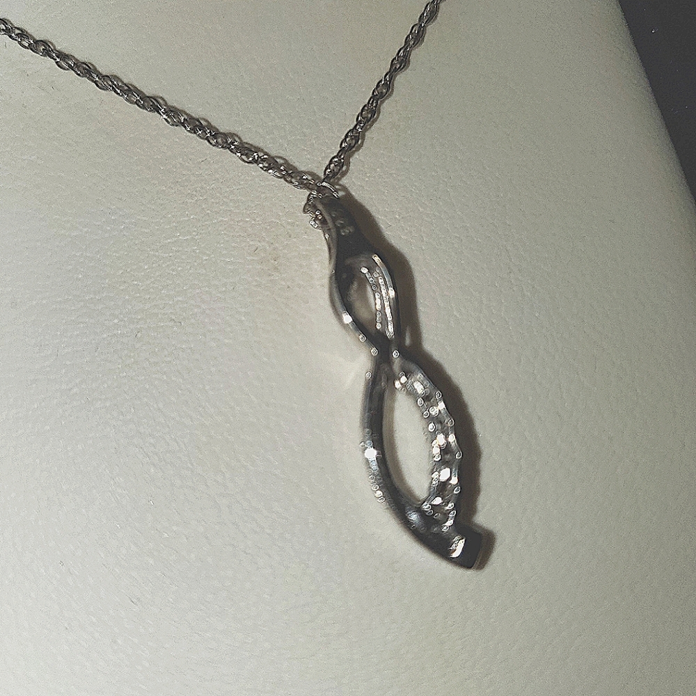 Pendent necklace .with diamonds on it.